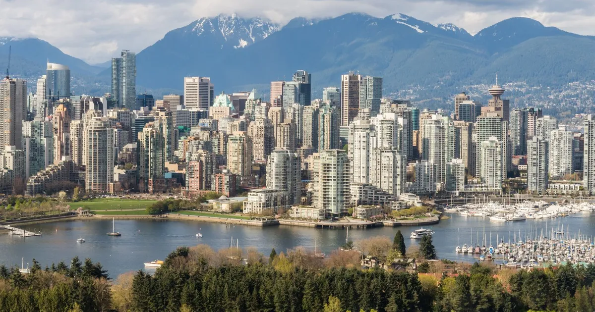 Downtown Vancouver towers above False Creek with the North Shore mountains behind, where loans Vancouver residents take out online follow BC rules